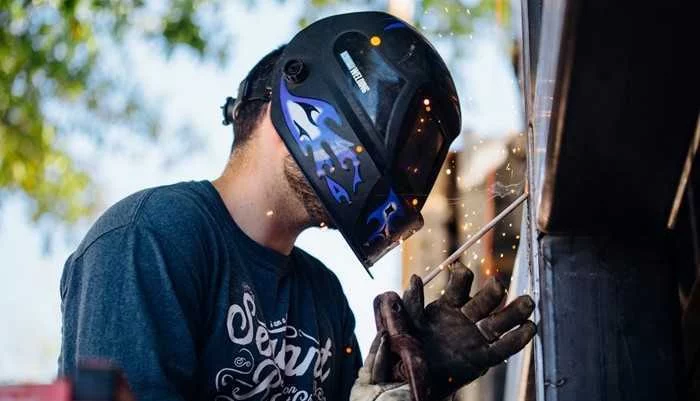Welder working on a metal beam